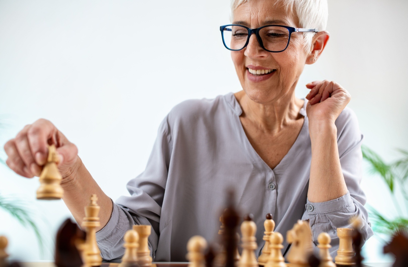 A senior parent plays a game of chess.